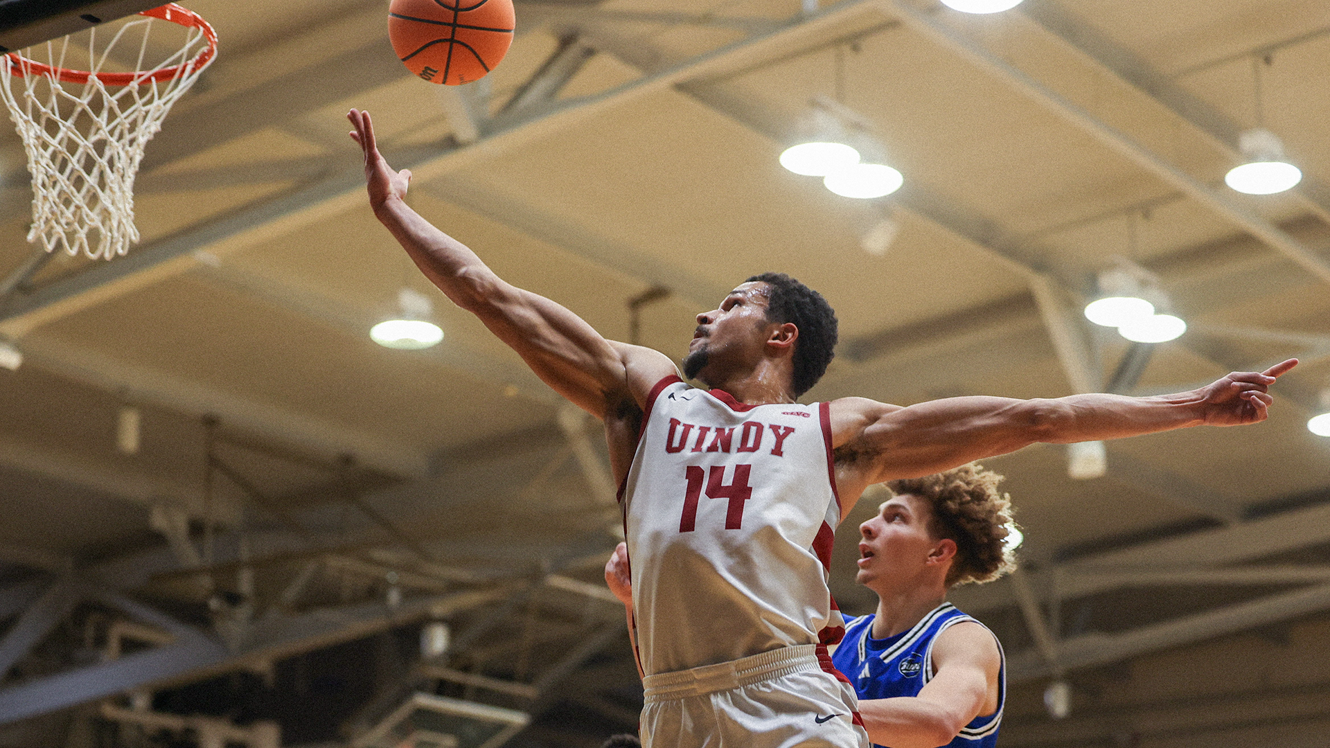 Pierce Thomas goes for a layup past GVSU player.