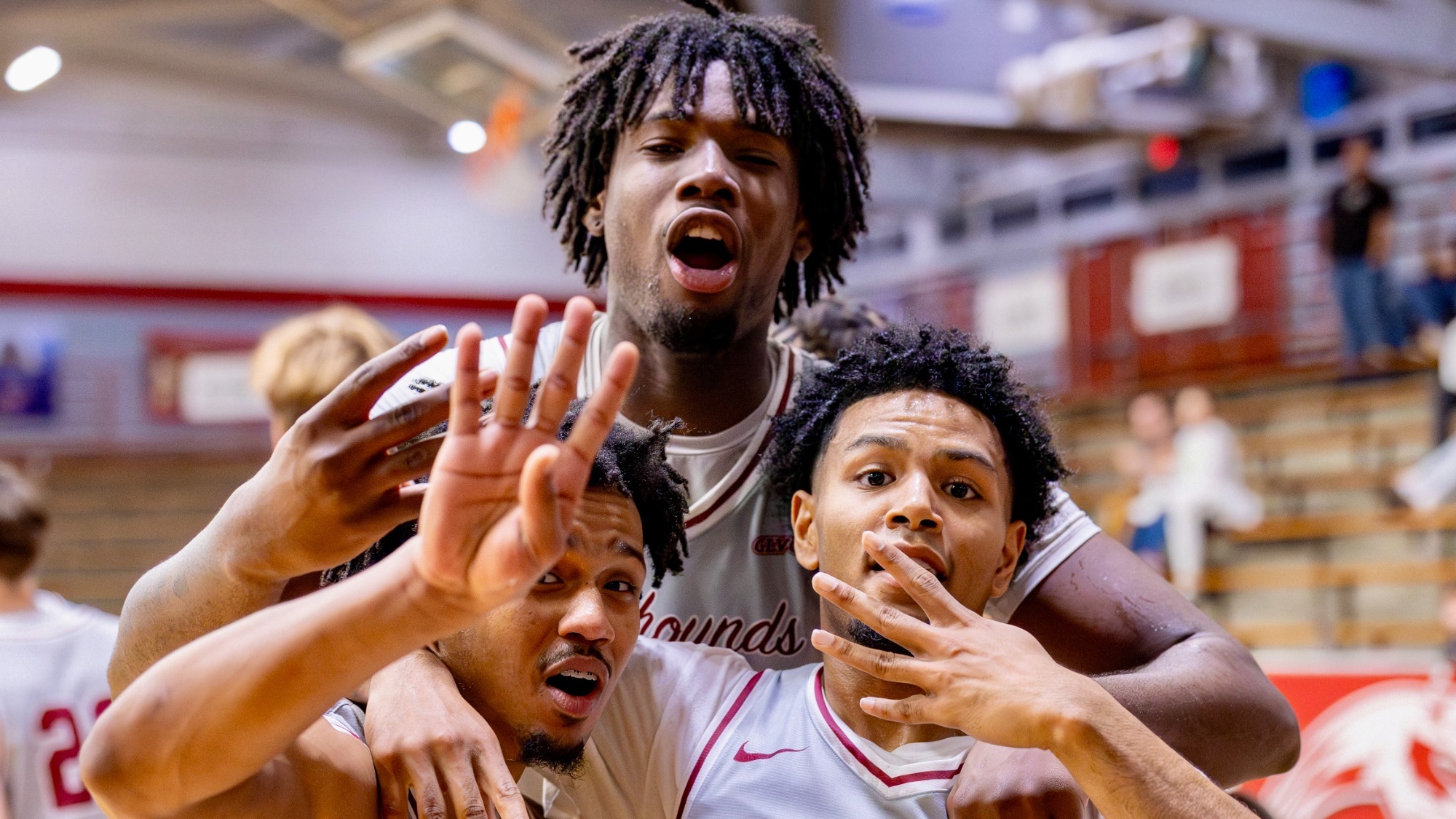 Men's Basketball players celebrate a win