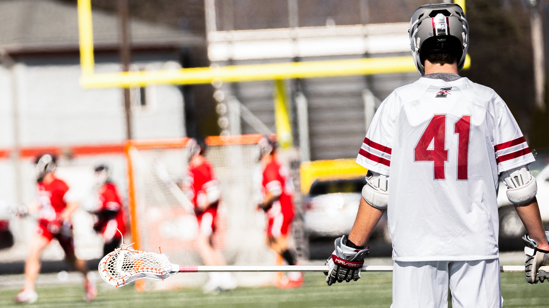 Alec Score watches on from the opposite side of the field.