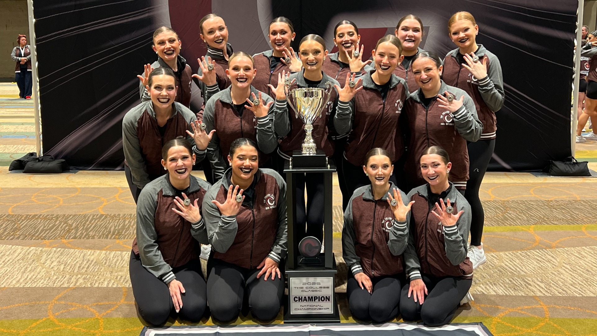 The UIndy dance team with their national championship rings and trophy.
