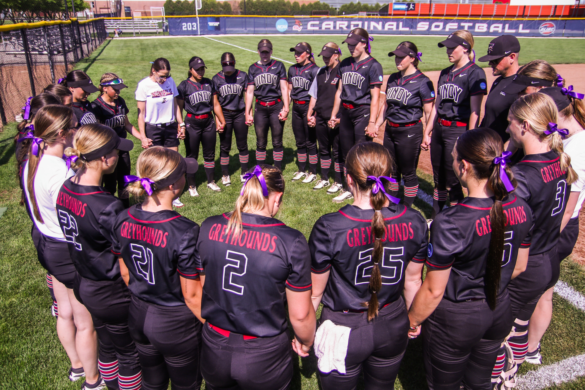 The UIndy softball team huddled in a circle before the game.