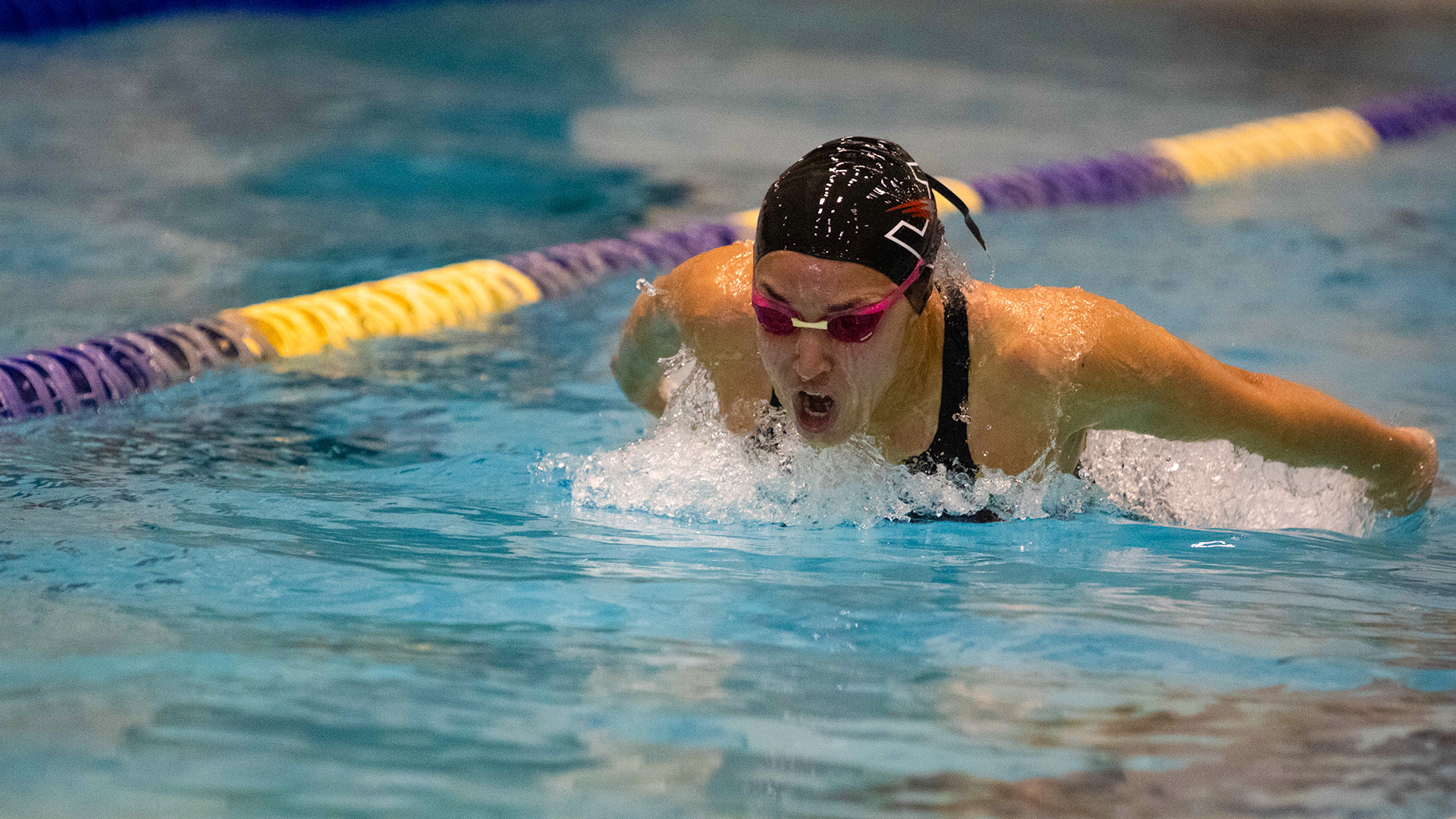 UIndy swimmer Valentina Masella competing in a butterfly race.
