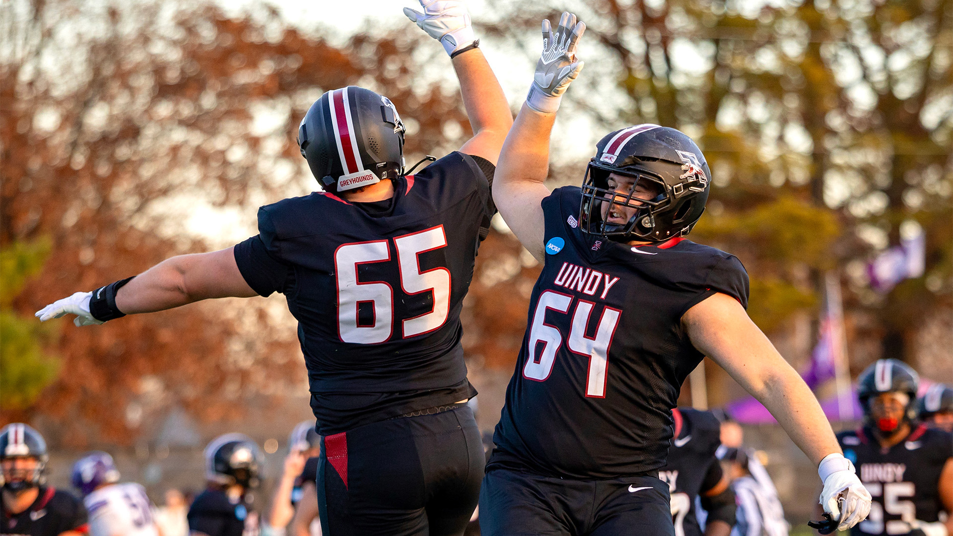 UIndy football offensive linemen Ryne Buttz and Tyler Leopold celenbrating.