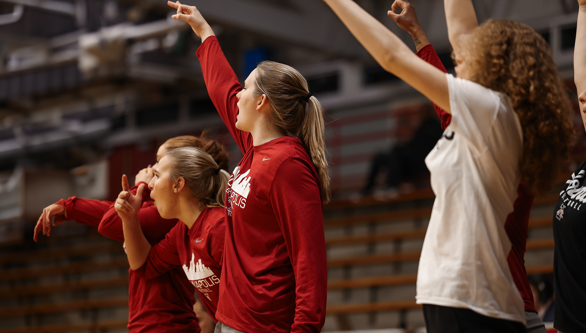 UIndy Women's Basketball bench celebrating