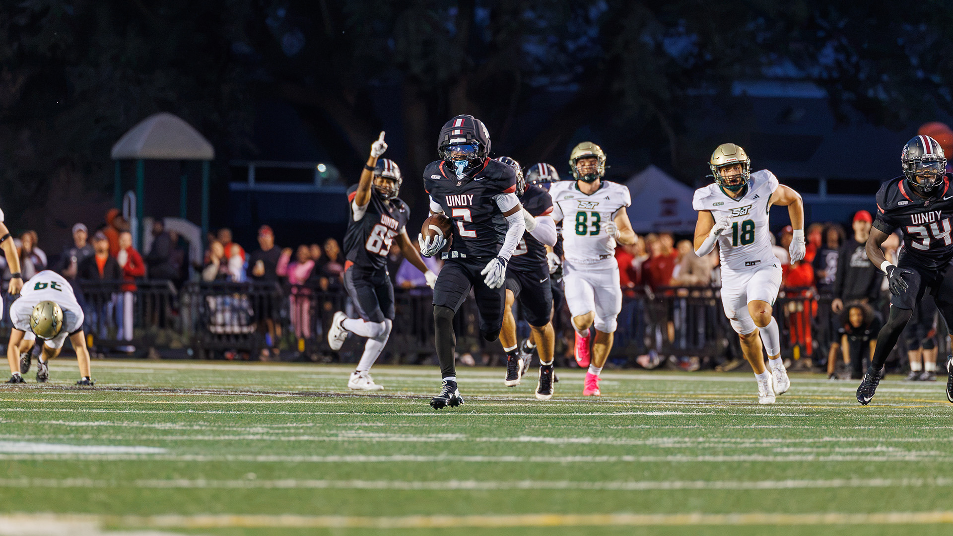 UIndy football student-athlete Anthony Crowell returning a punt.