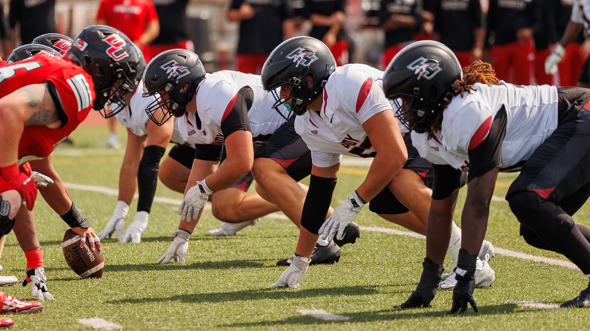 The UIndy football defensive line lines up before the snap.