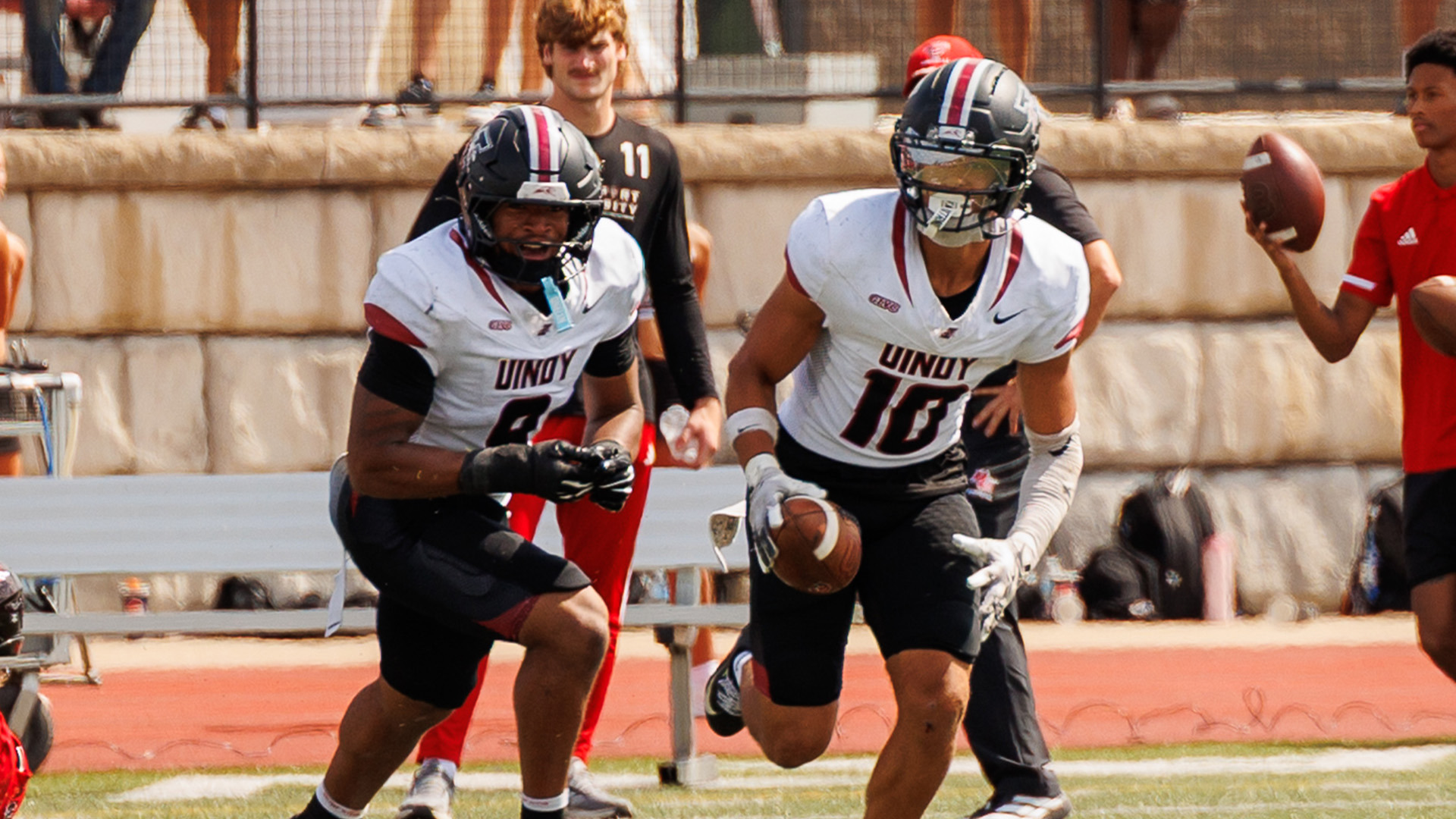 UIndy football defenders DeBrince Johnson and TJ Cothron celebrate a turnover.