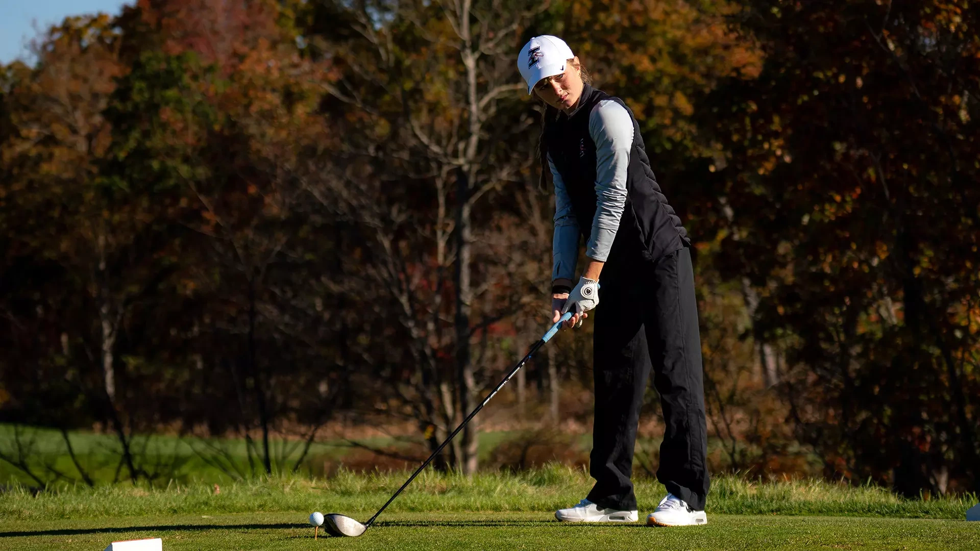 UIndy golfer Grace Hickey addressing the ball on the tee box.
