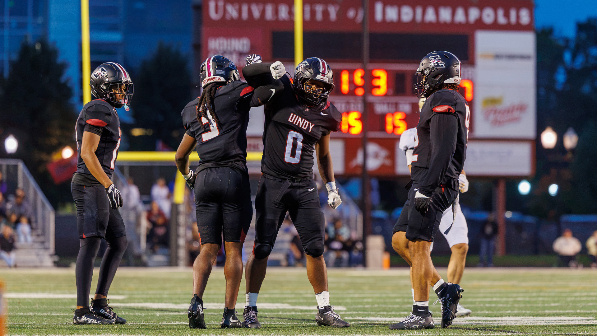 UIndy football linebacker Jerrell Franklin celebrating with teammates.