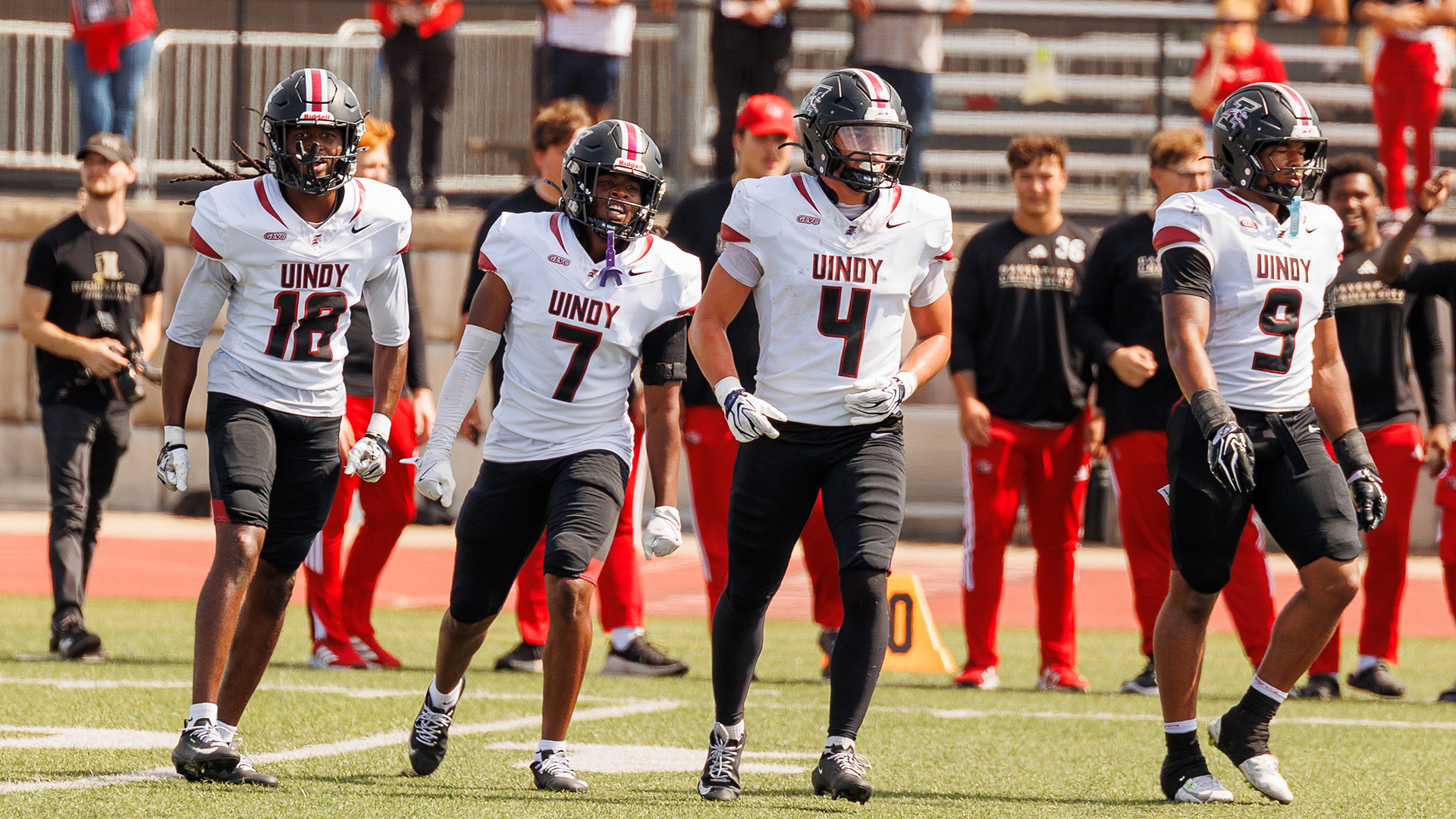 Members of the UIndy football defense on the field.
