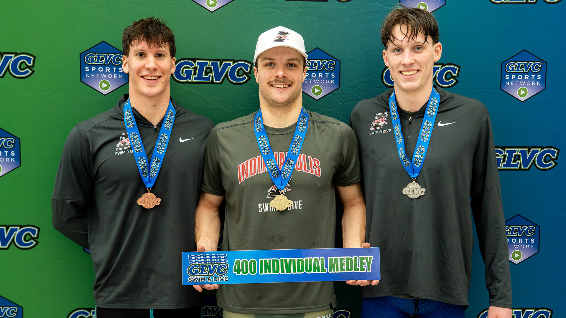 Nico Basten, Jeremias Pock and Silas Buessing display their 400 IM medals.