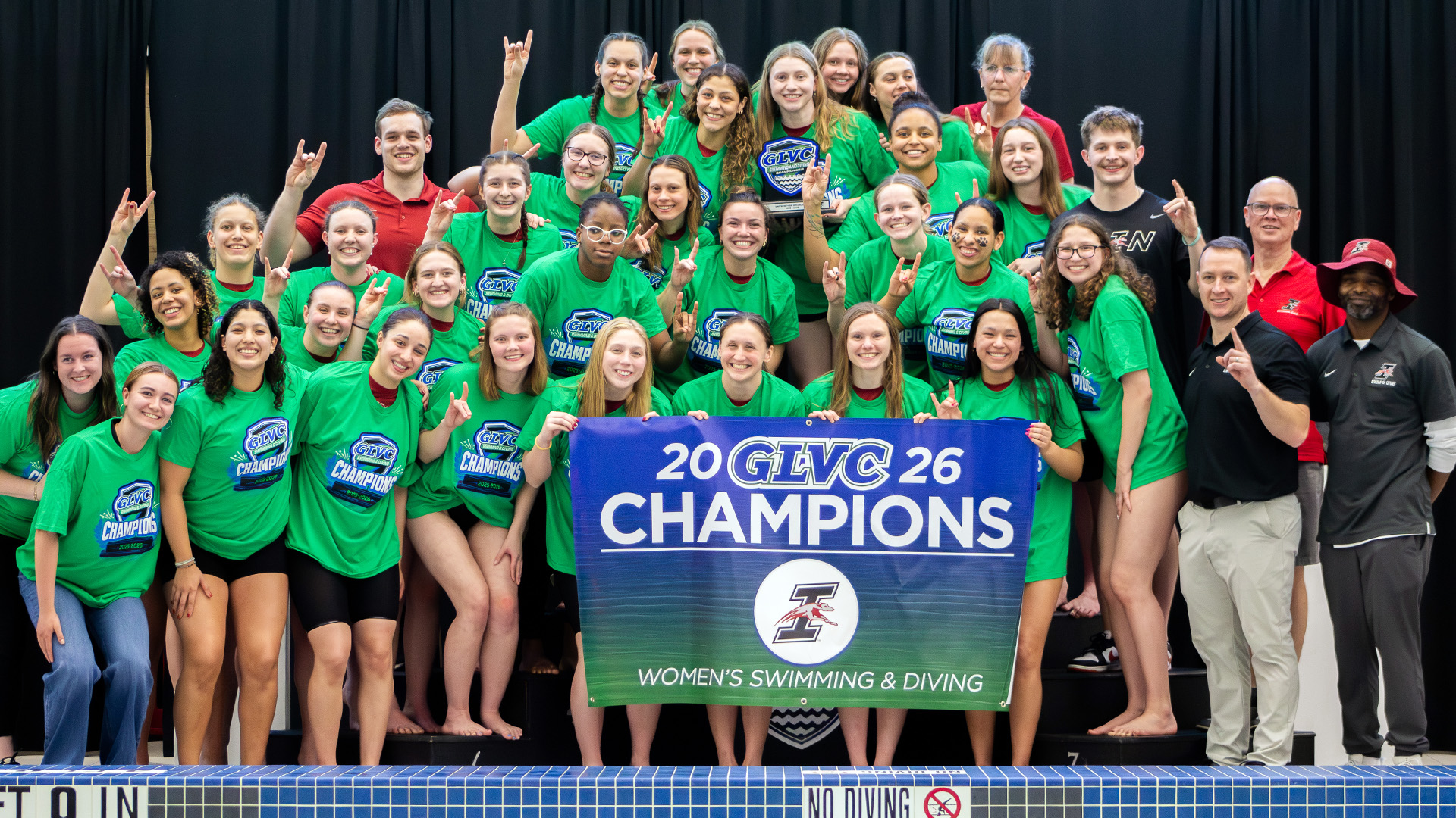 The UIndy women's swimming and diving team pose with the 2026 GLVC Championship trophy.