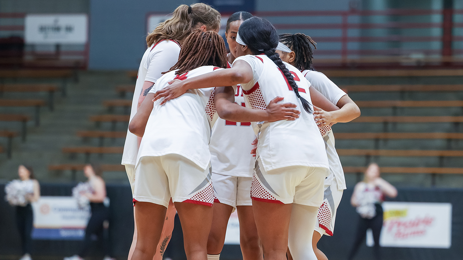 UIndy women's basketball huddles