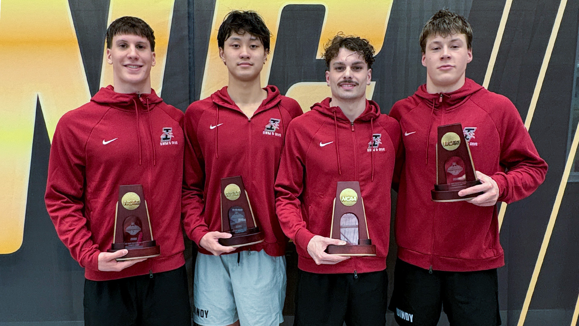 Men's 800 free relay team members Nico Basten, Harrison Andokoi, Swann Plaza and Jan Schmidt pose with their All-Americ trophies.