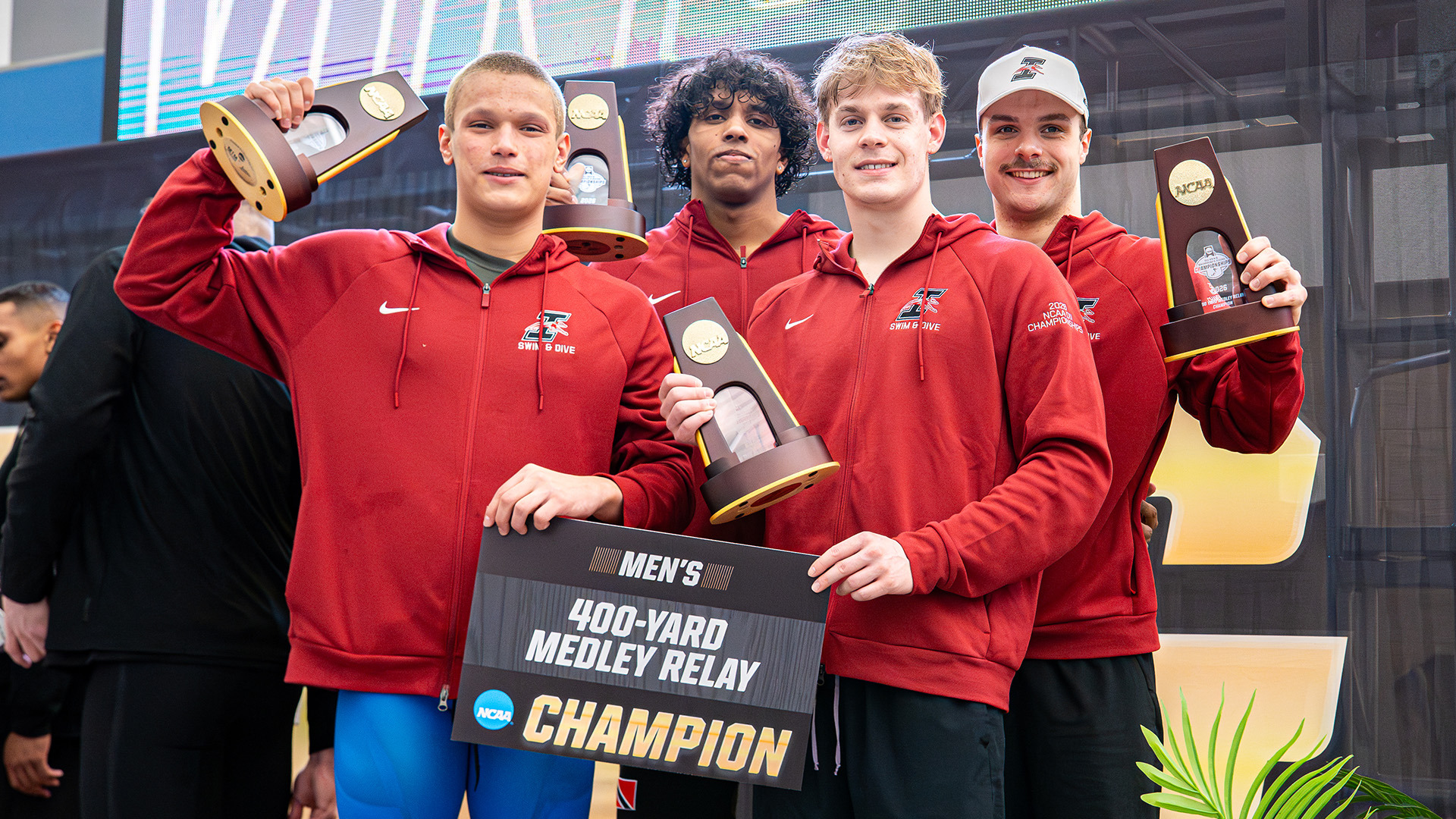 The UIndy men's 400 medley relay team display their national championship trophies at the 2026 NCAA DII Championships.