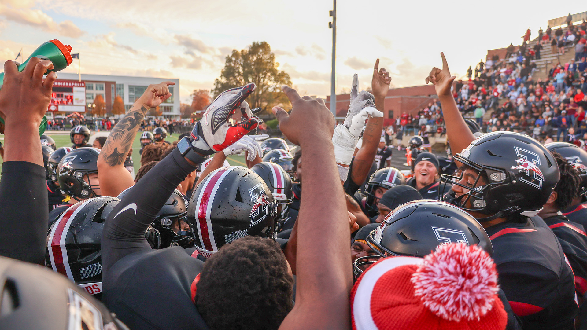 Members of the UIndy football team celebrating a win.