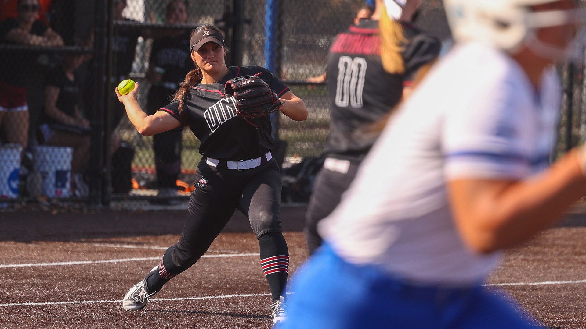 UIndy softball third baseman Maya Rodriguez throwing the ball the first.