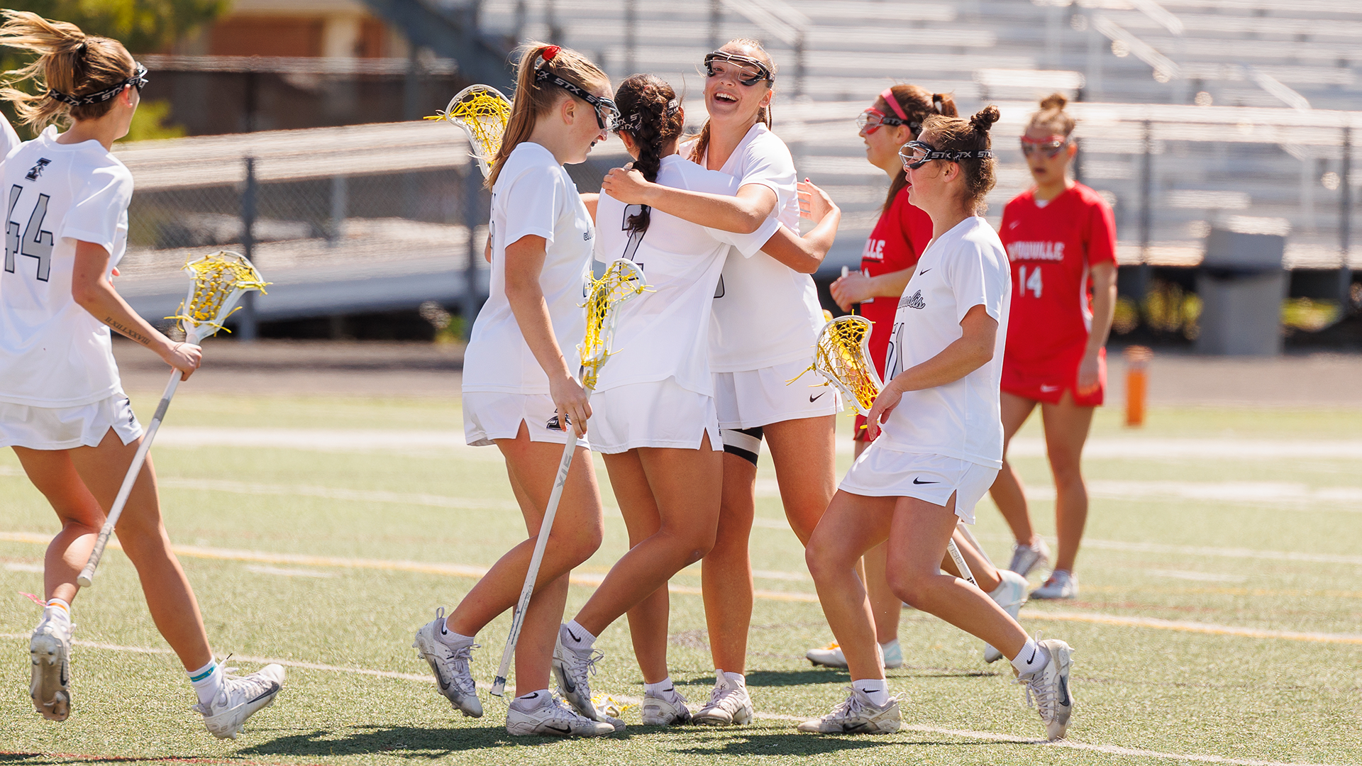 UIndy women's lacrosse celebrating a goal