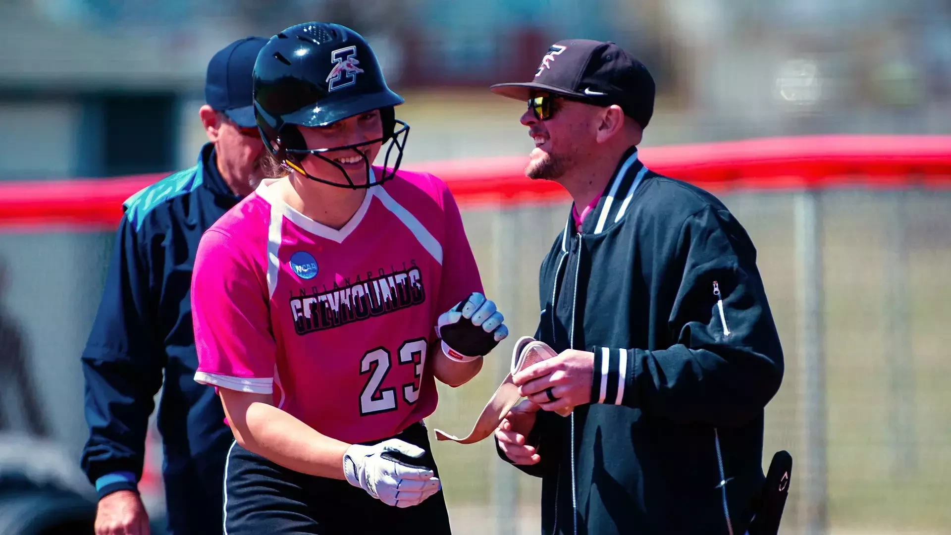 Shelby Cook shares a laugh with first base coach Ben Ferrell.