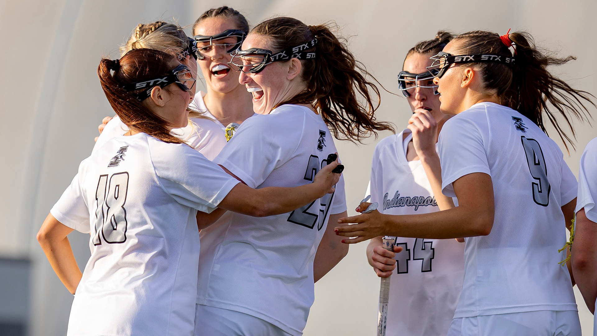UIndy women's lacrosse celebrating a goal