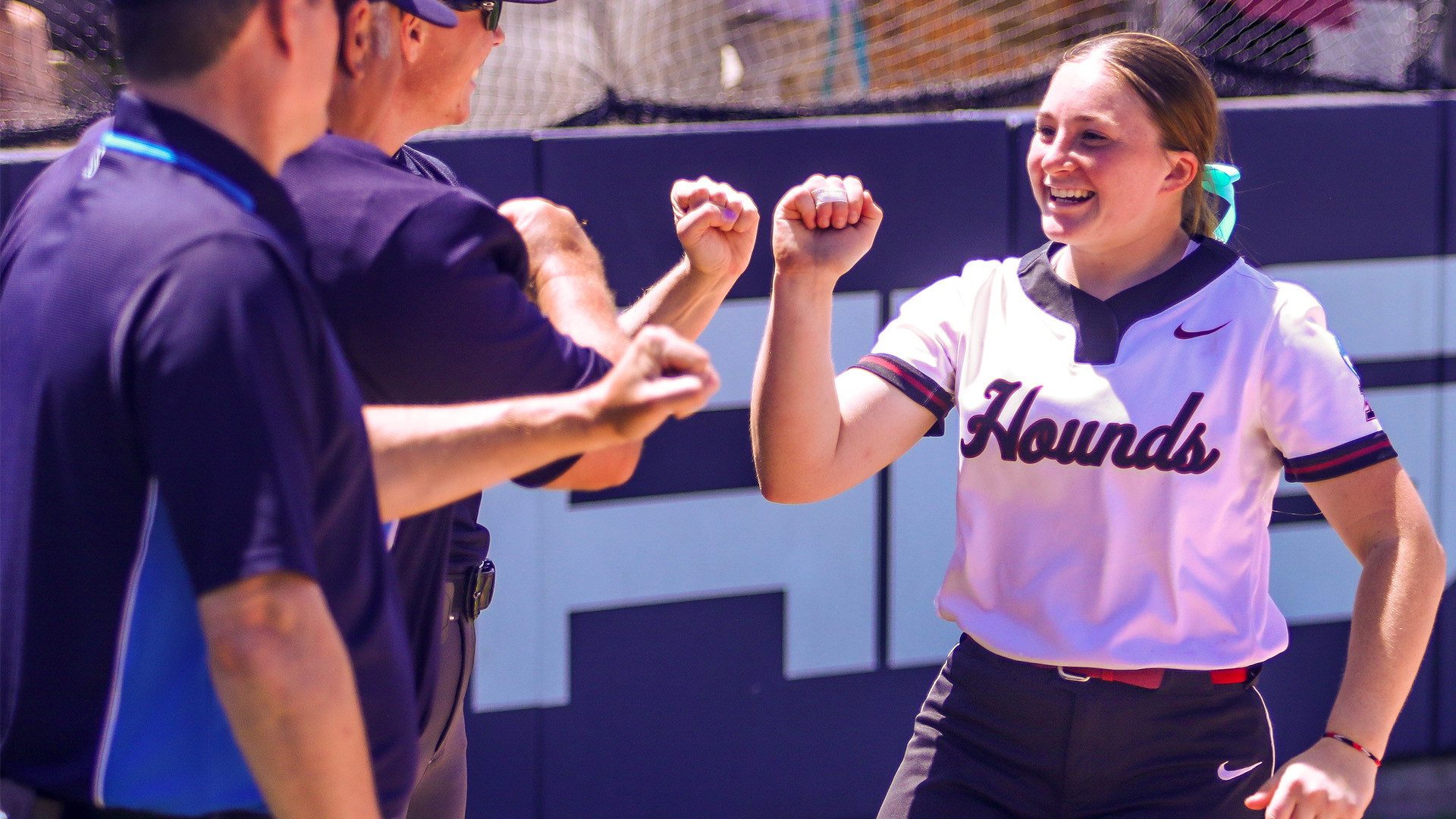 Cheyenne Eads fist bumoing the umpires before a game.