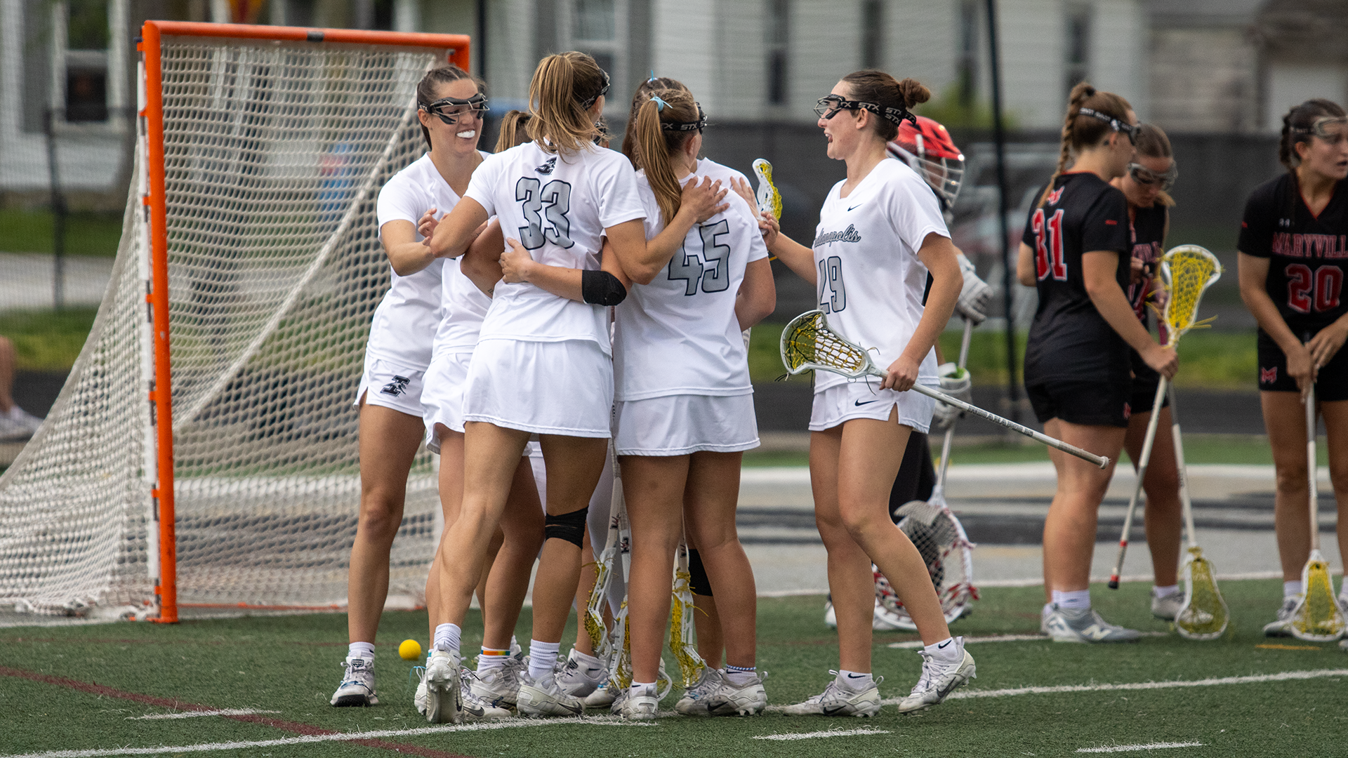 UIndy women's lacrosse celebrating a goal