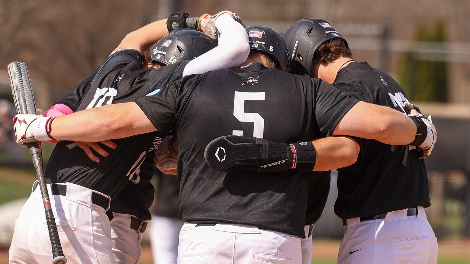 UIndy celebrating a home run