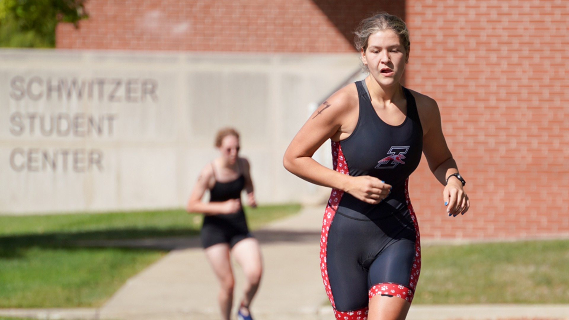 Miah Sosenheimer runs by Schwitzer