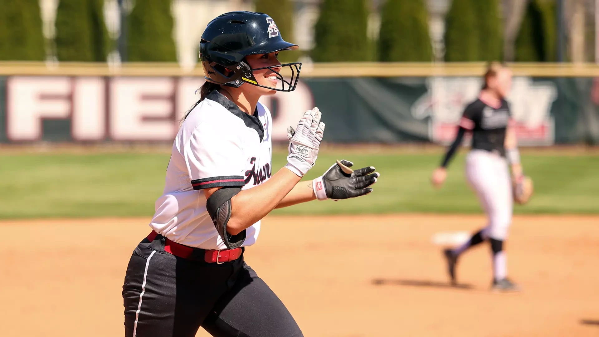 Josie Jager clapping as she trots home to score.