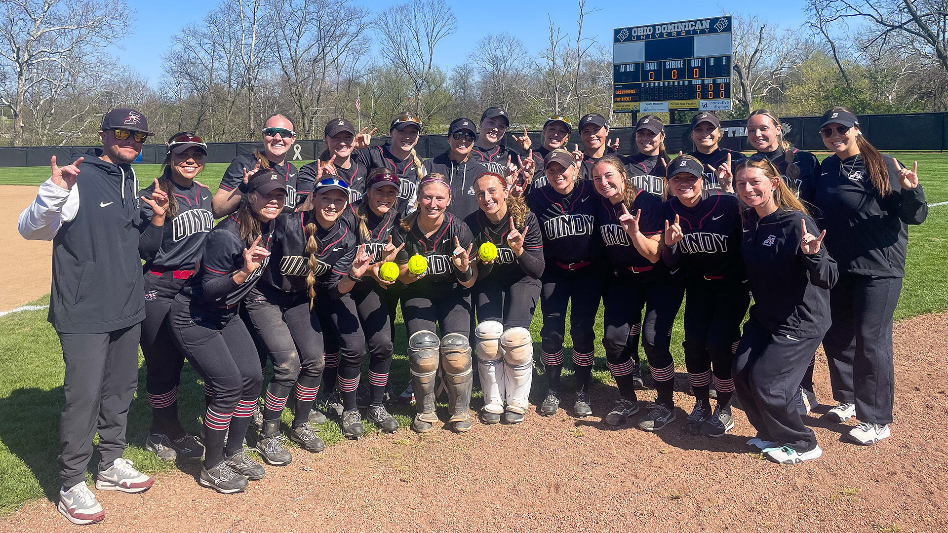 The UIndy softball team poses with head coach Missy Frost after her 900th win at UIndy.
