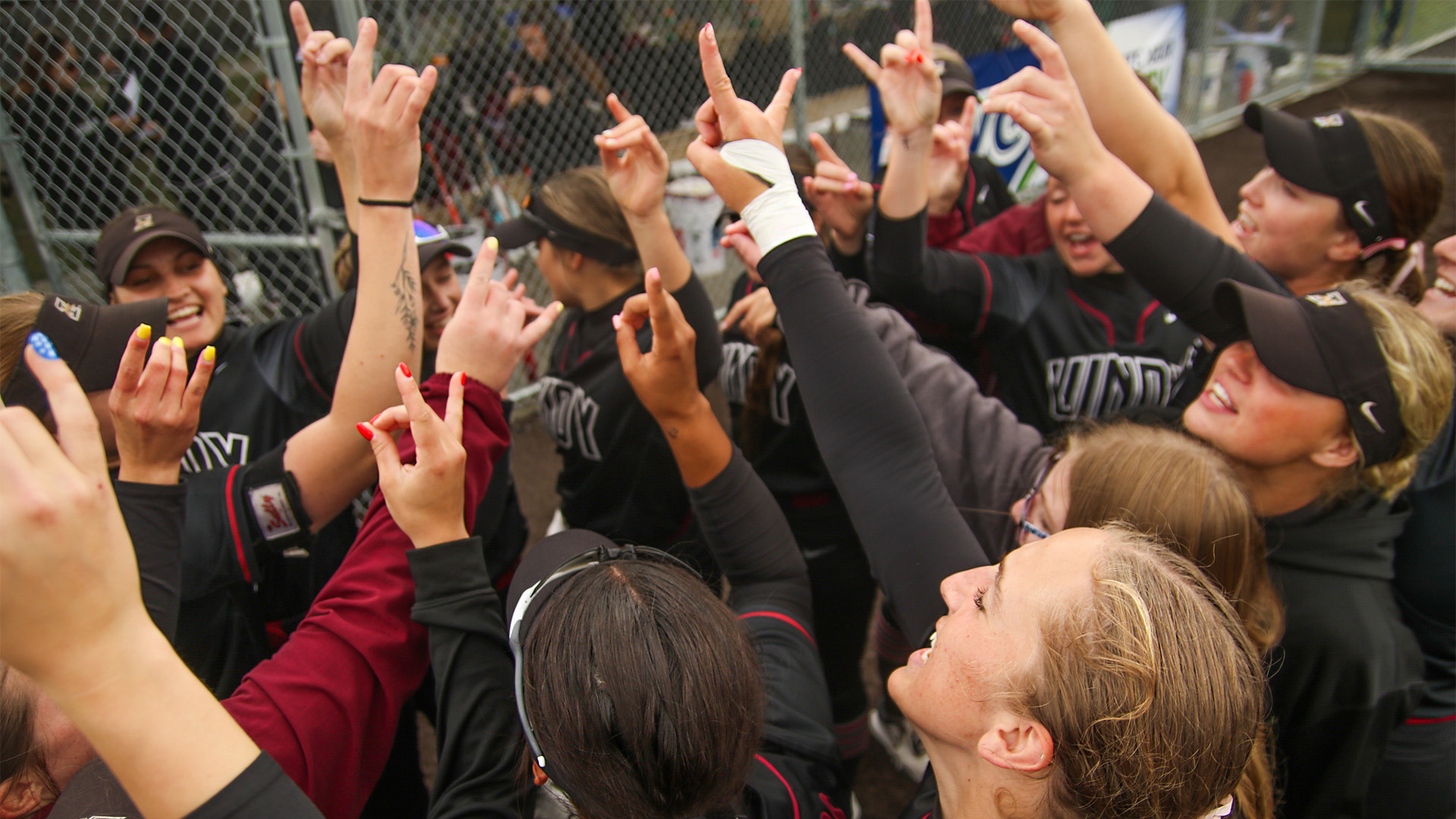 The UIndy softball team celebrating after a win.