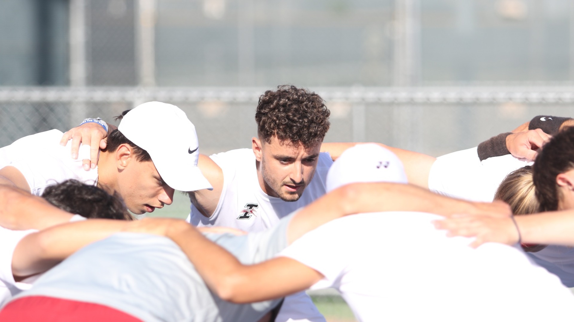 UIndy men's tennis team huddle