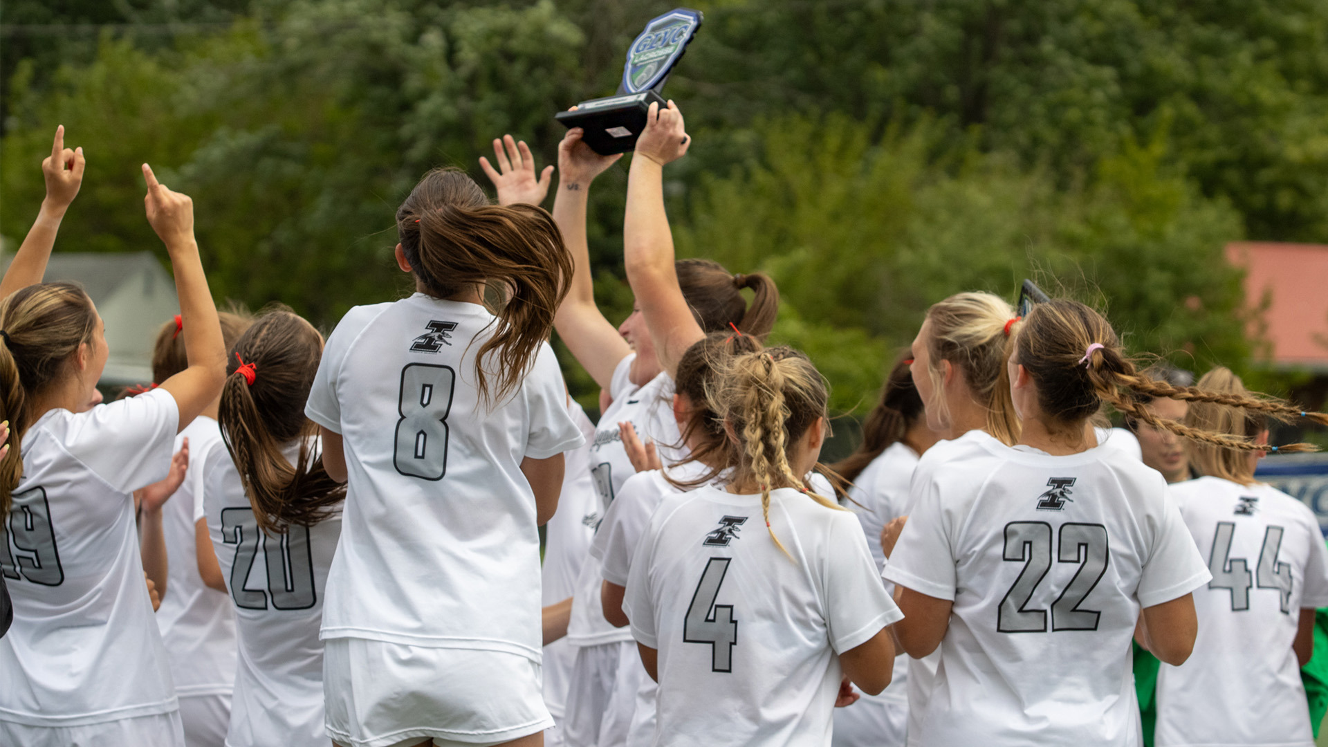 The UIndy women's lacrosse team celbrates with the 2026 GLVC Championship trophy.