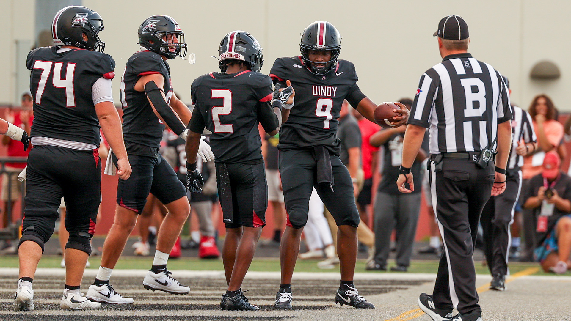 UIndy quarterback Nick Patterson celebrates a touchdown with teammates.