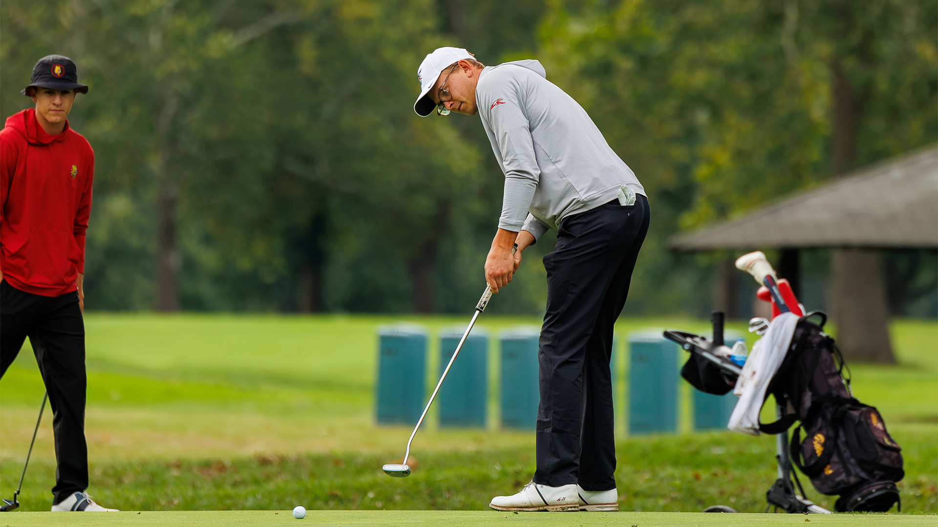 UIndy senior golfer Alexander Nestun putting.