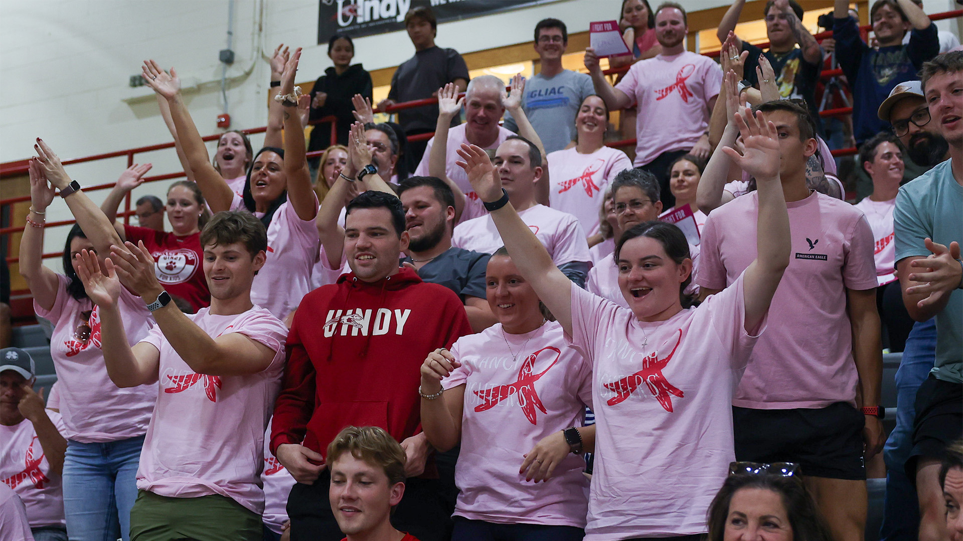 UIndy volleyball fans cheering at the team's Dig Pink event.