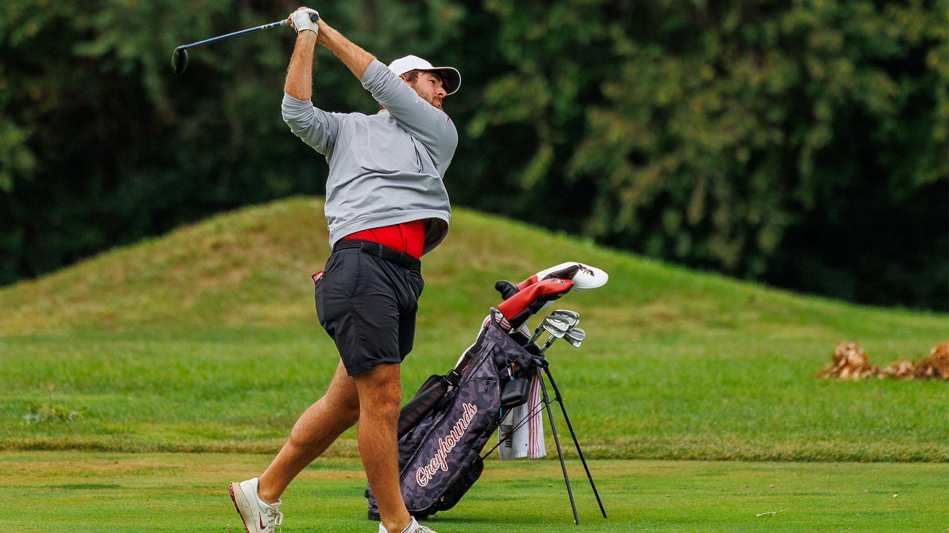 UIndy golfer Joseph Armfield hitting a fairway wood.