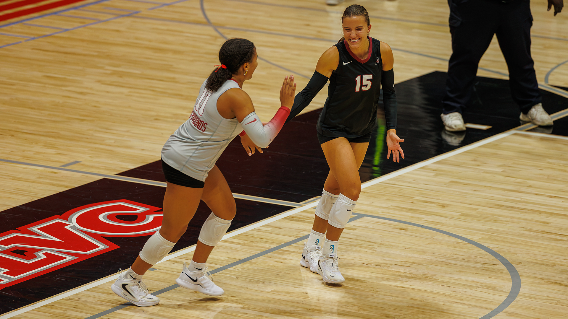 Mya Trammell and Makenzie Pflederer celebrate a point at the UIndy Invitational