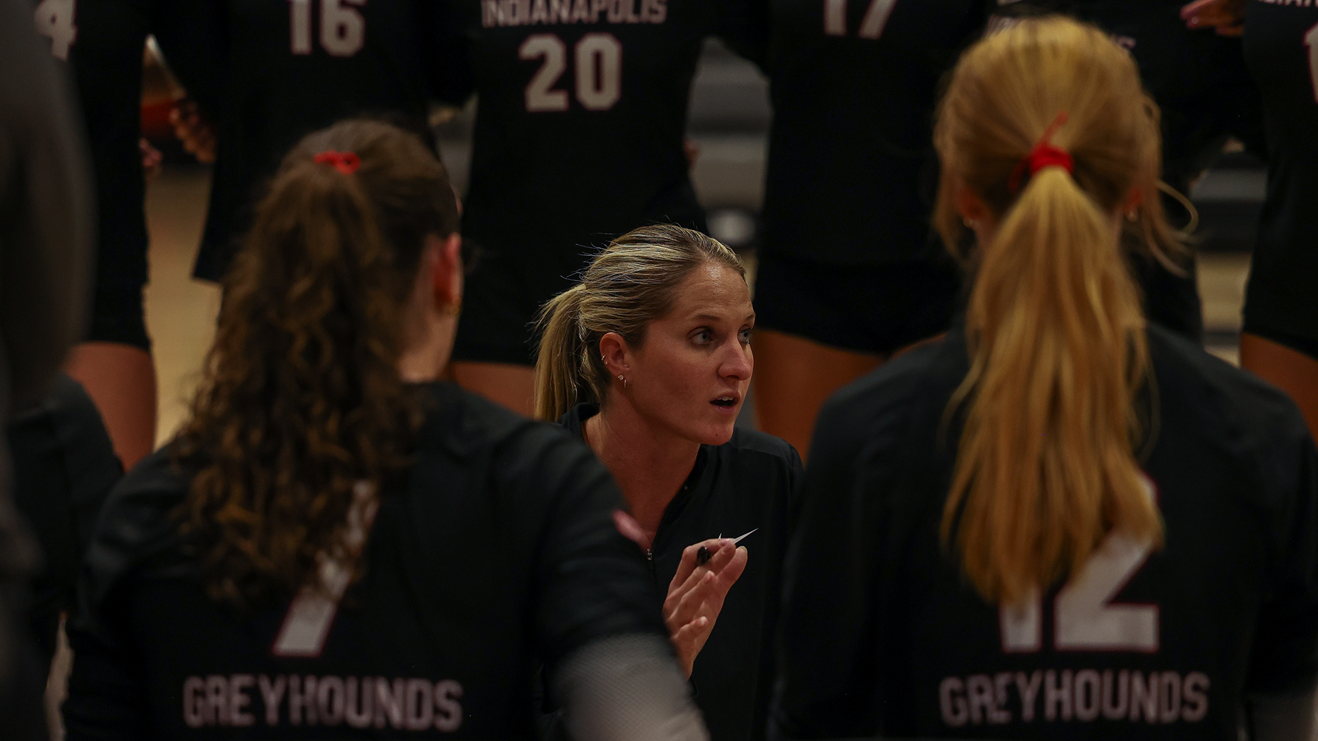 Coach Case talks to the UIndy Volleyball team in a huddle