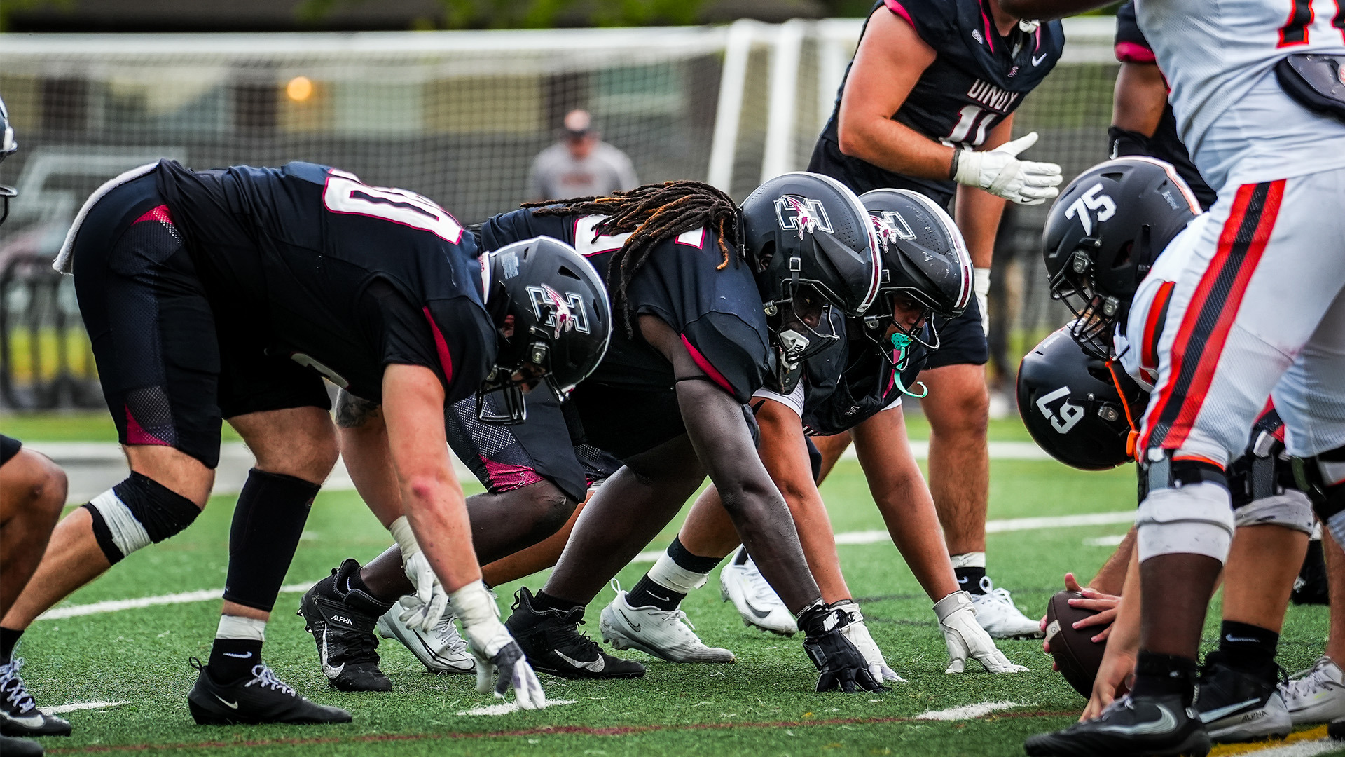 The UIndy football defensive line pre-snap.