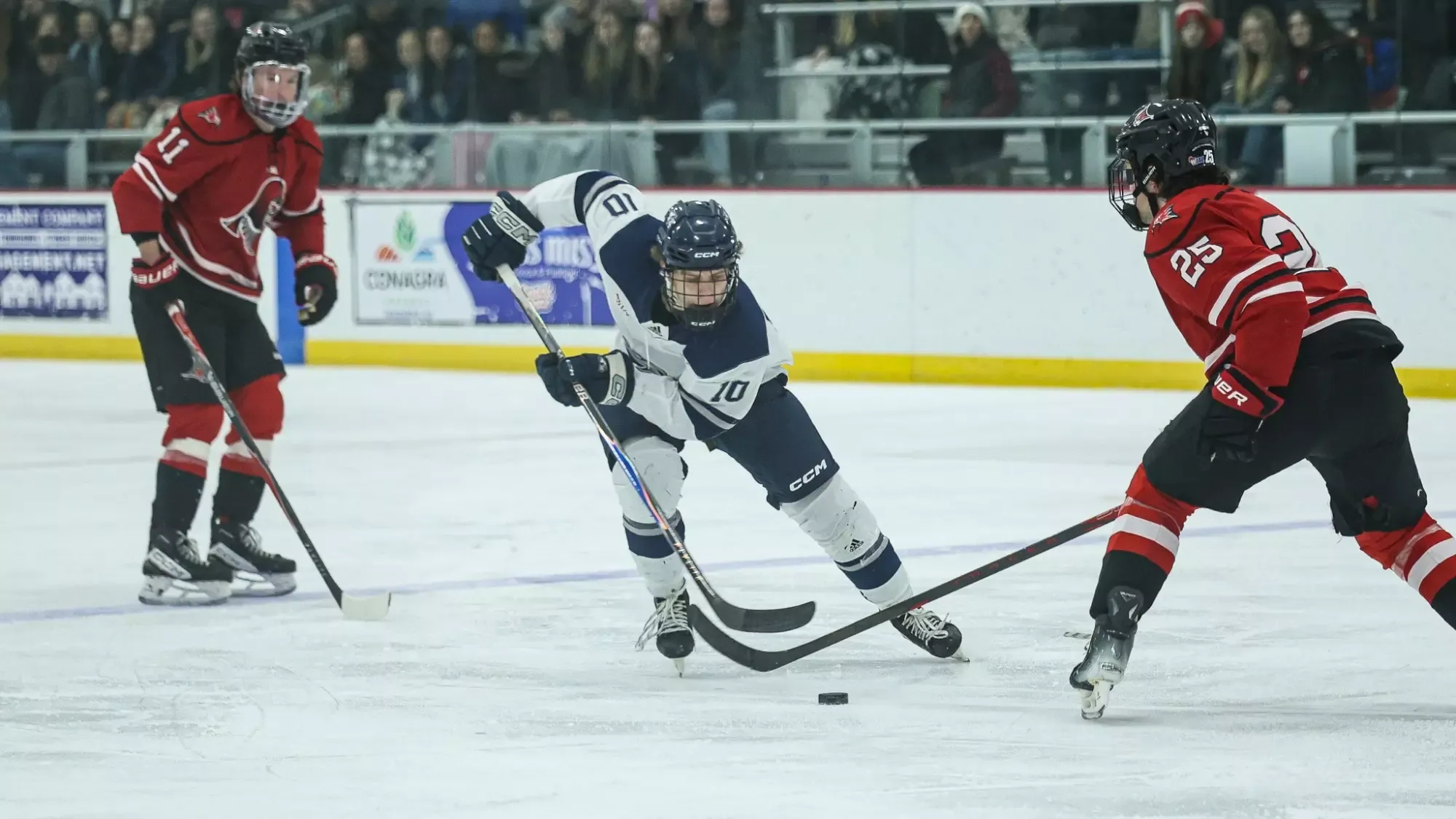 Stocks handling the puck through River Falls defenders