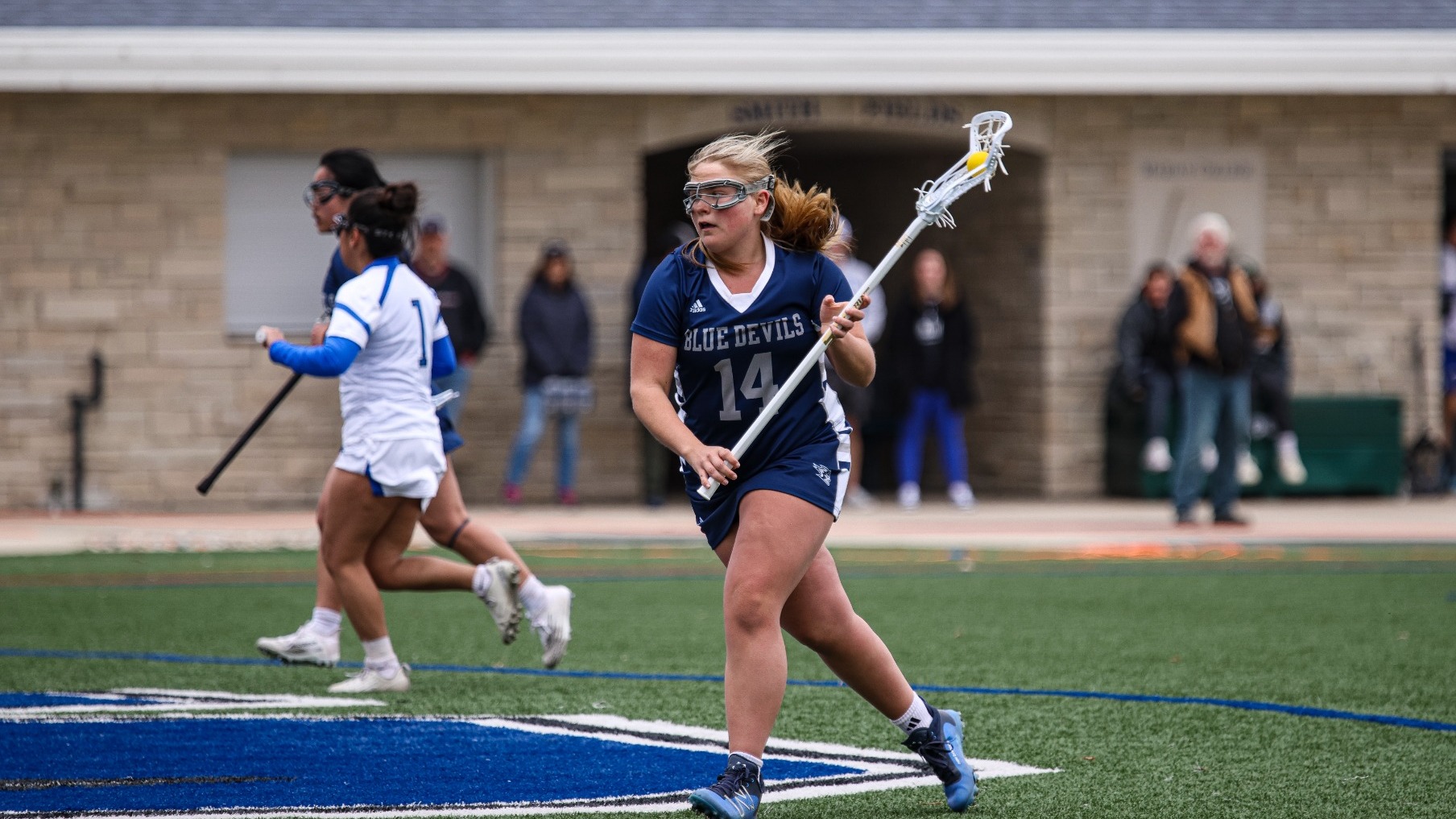 Lilly runs with ball at marian