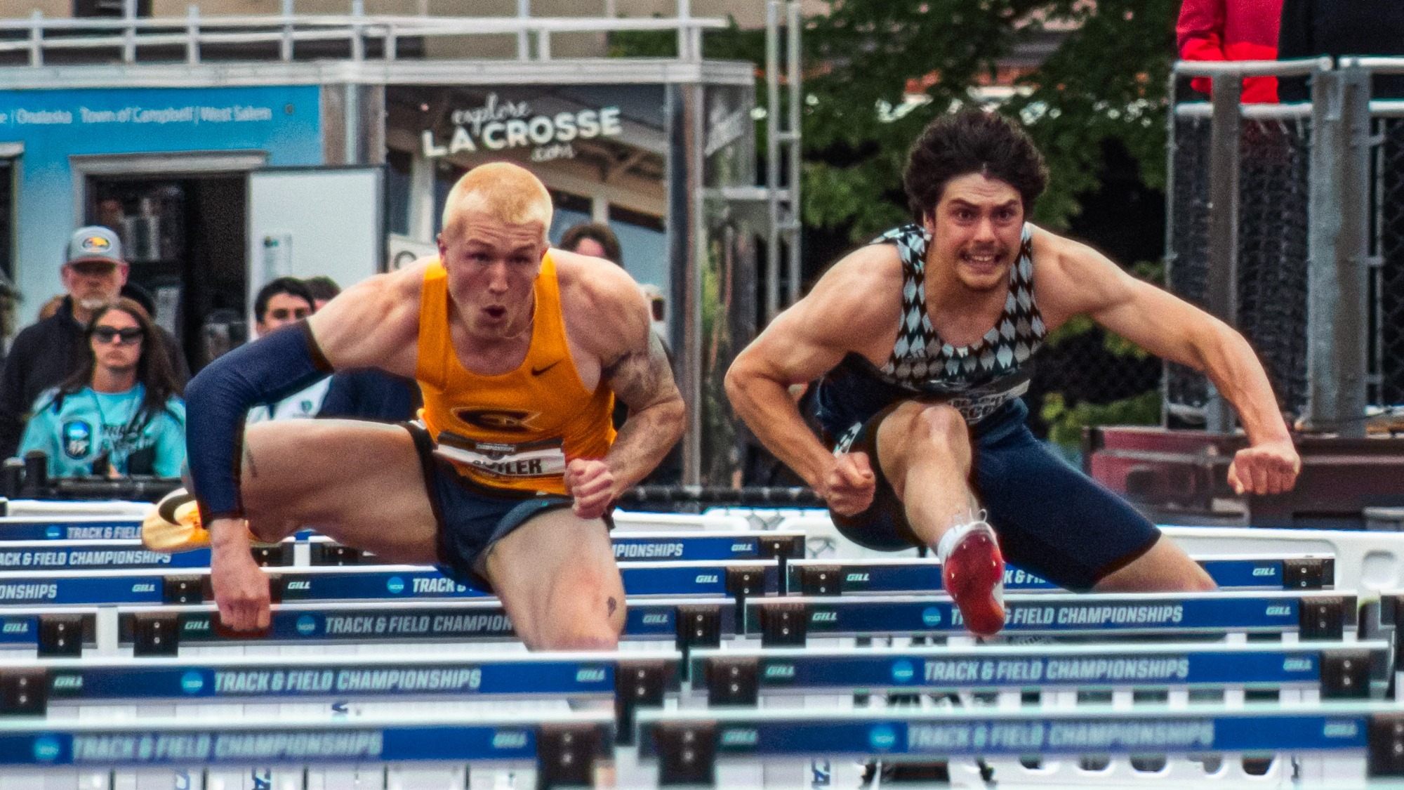 Driscoll duels a UWEC runner in the hurdles