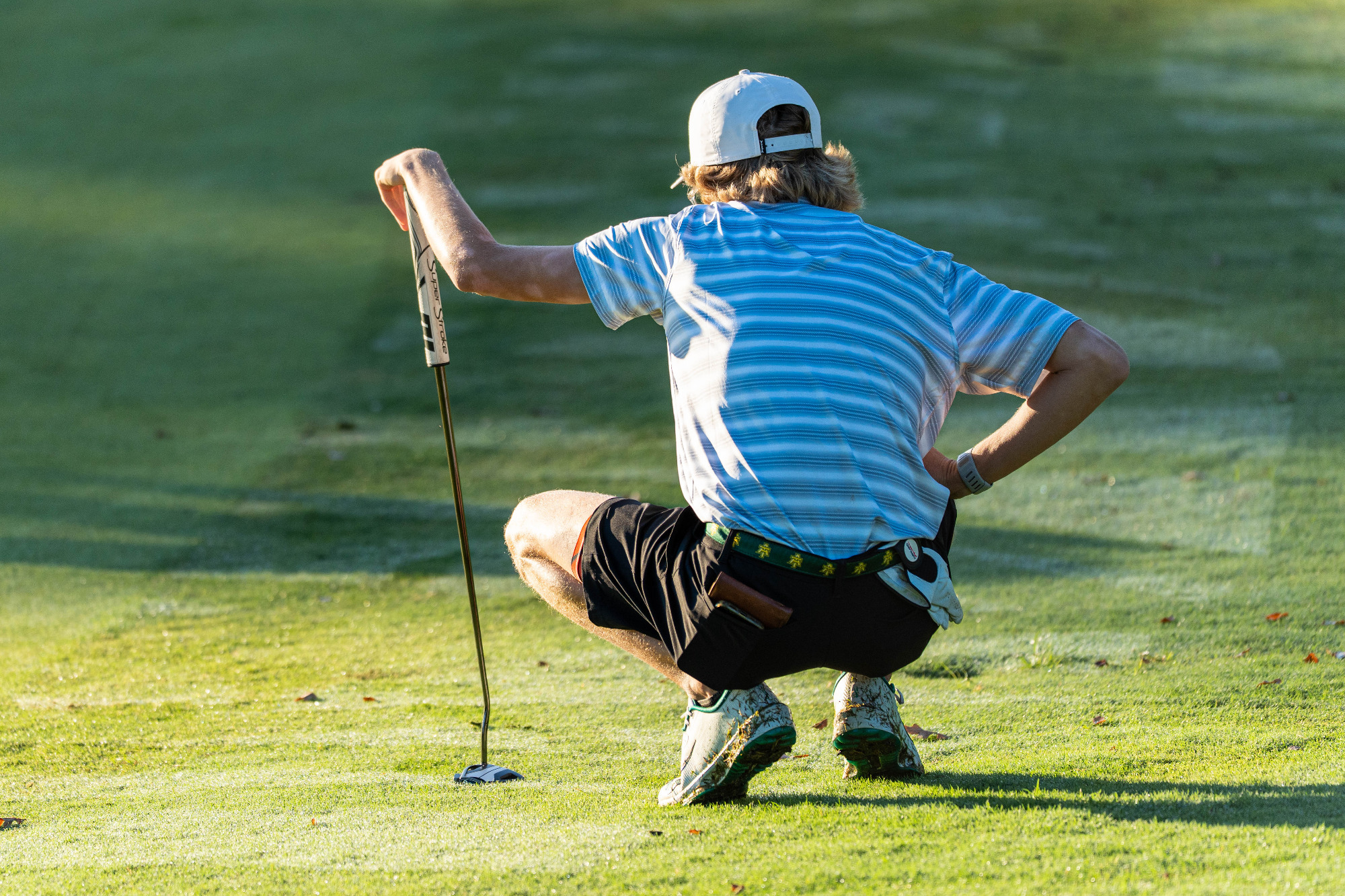 Nicholas Norris reading a putt