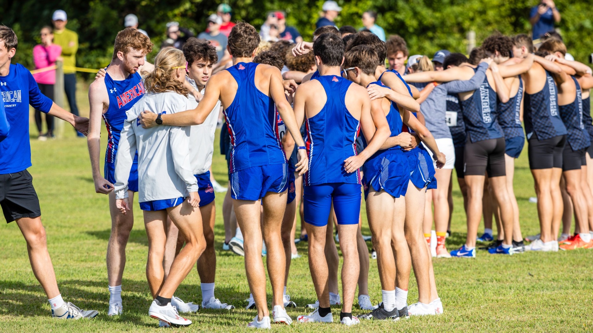 Men's cross country huddle before the 2025 Richmond Spider Alumni Open