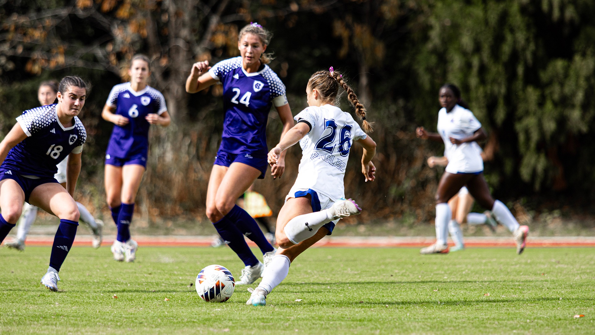 Phoebe Merrigan playing in a women's soccer game against Holy Cross