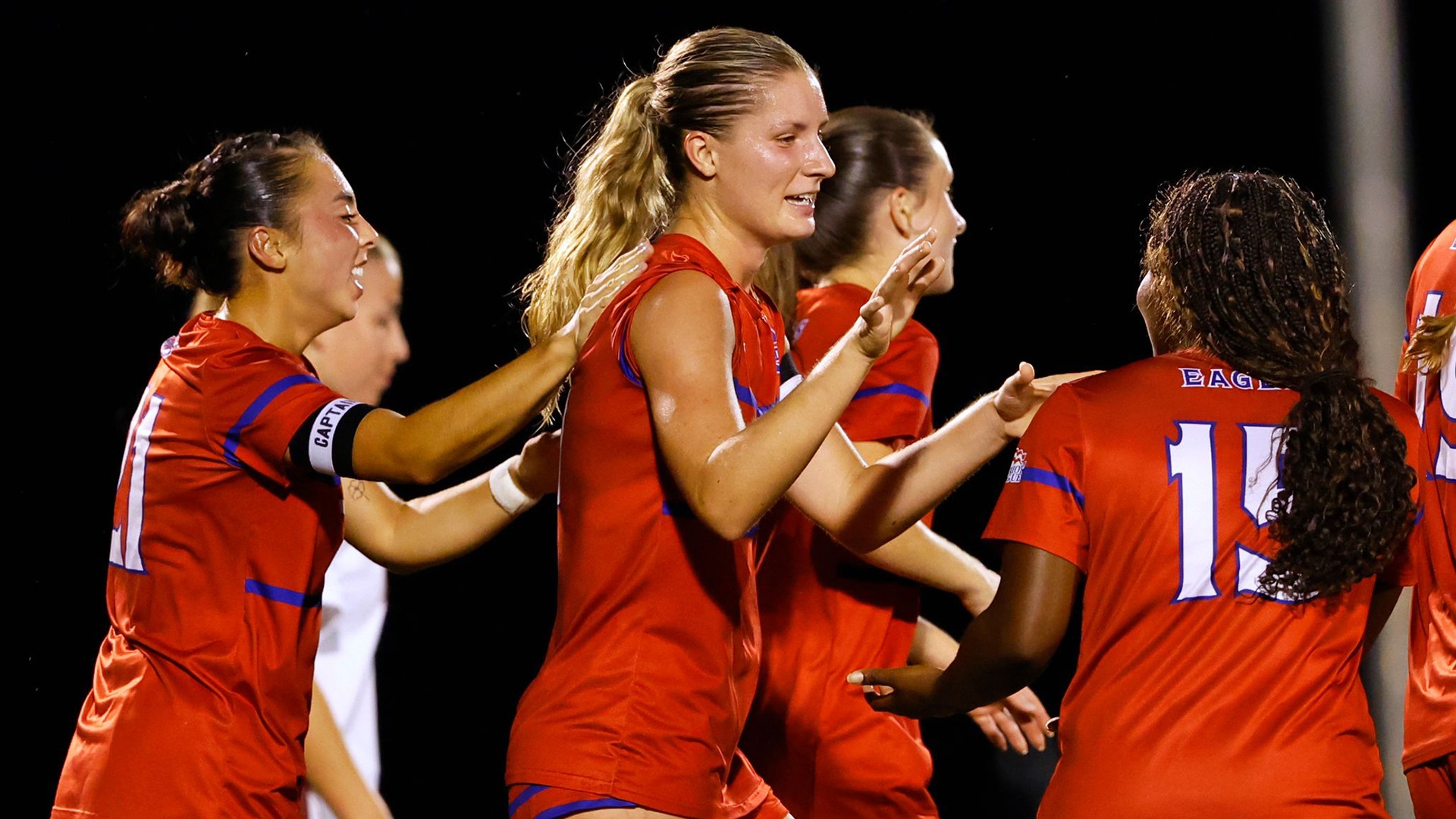 Avery Klingensmith and Jennifer McGuire celebrating a goal in women's soccer