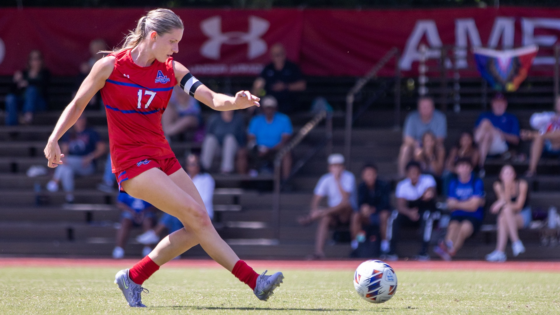 Avery Klingensmith kicking the ball during a women's soccer game at Reeves Field