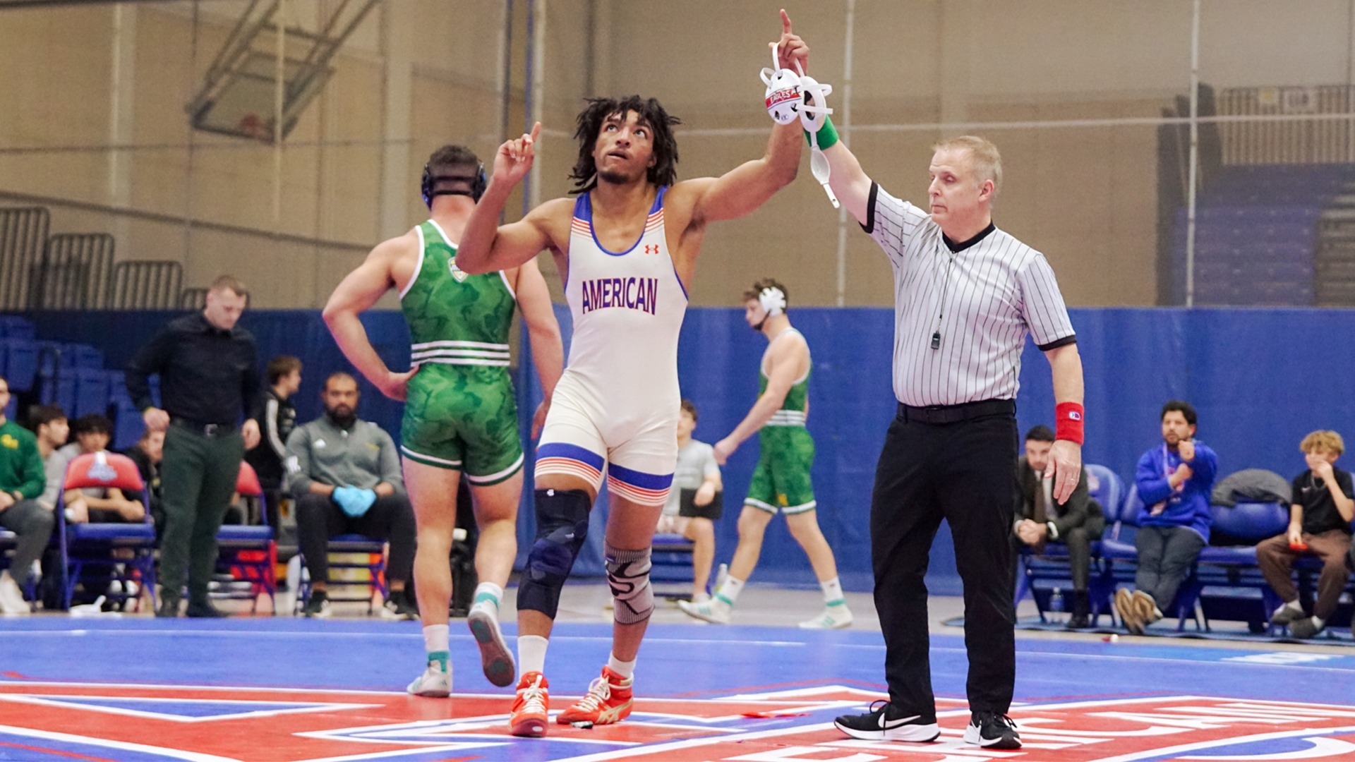 Caleb Campos getting his arm raised after winning a wrestling match over George Mason at Bender Arena.