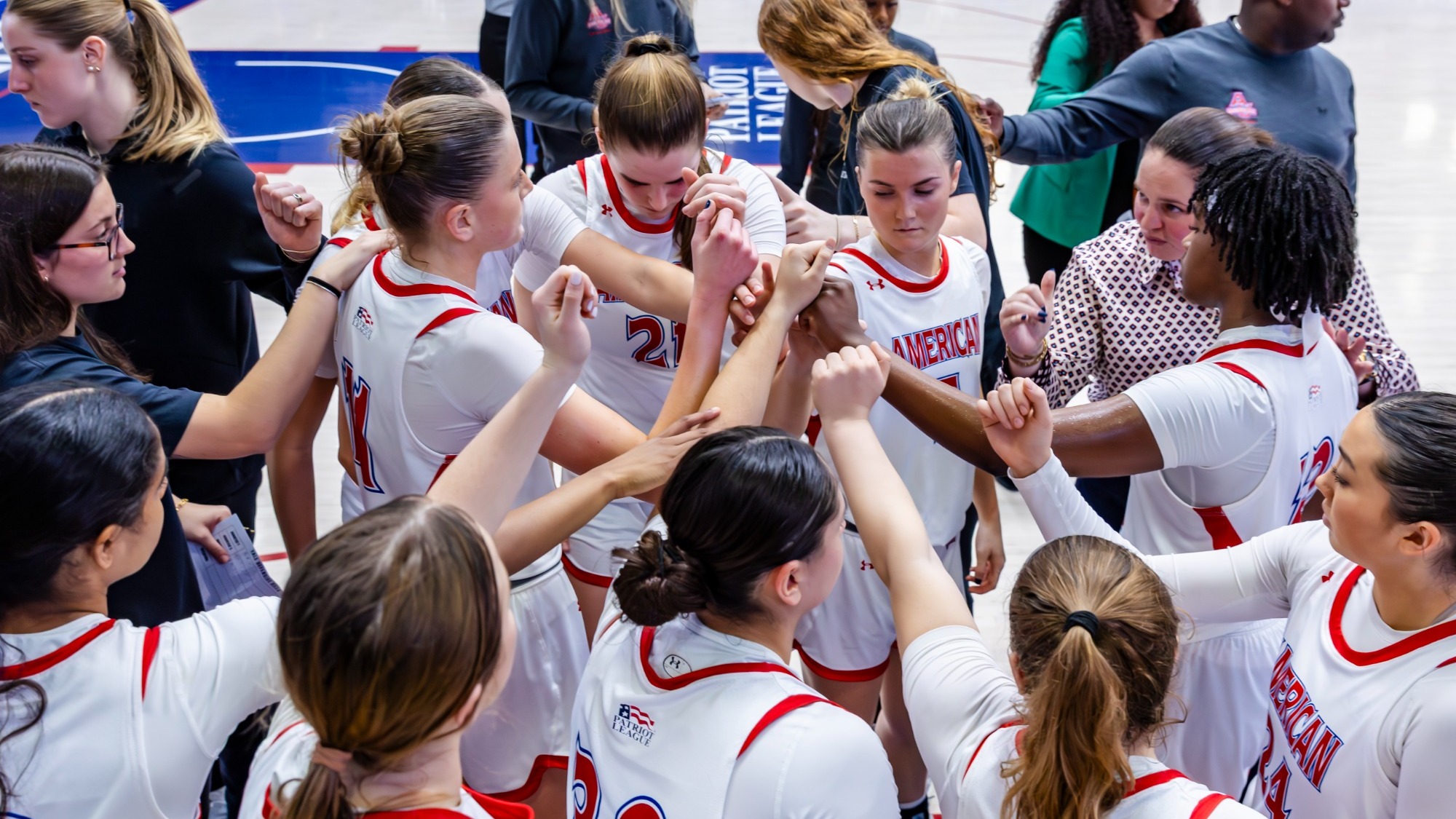 Women's Basketball huddles together during its game against Yale.